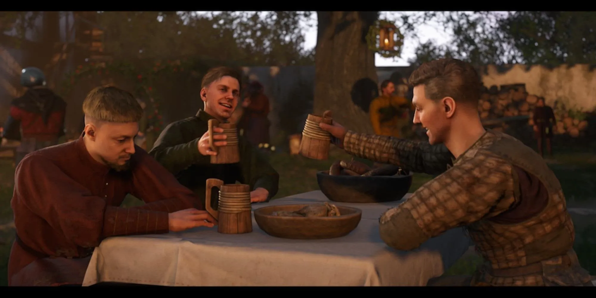 Các nhân vật đang ăn uống và trò chuyện vui vẻ trong một quán rượu thời trung cổ trong Kingdom Come Deliverance 2