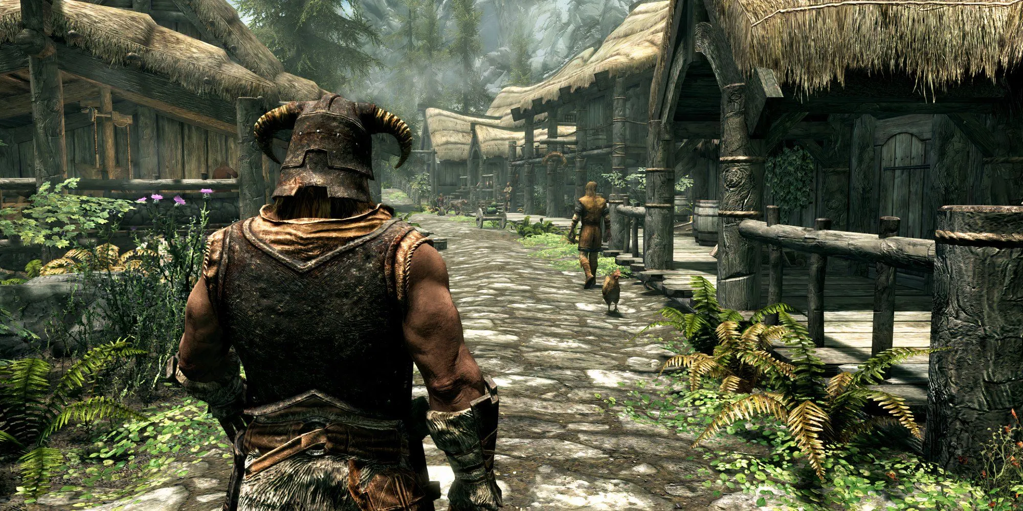 Nhân vật chính trong The Elder Scrolls V: Skyrim đứng quay lưng ở một ngôi làng