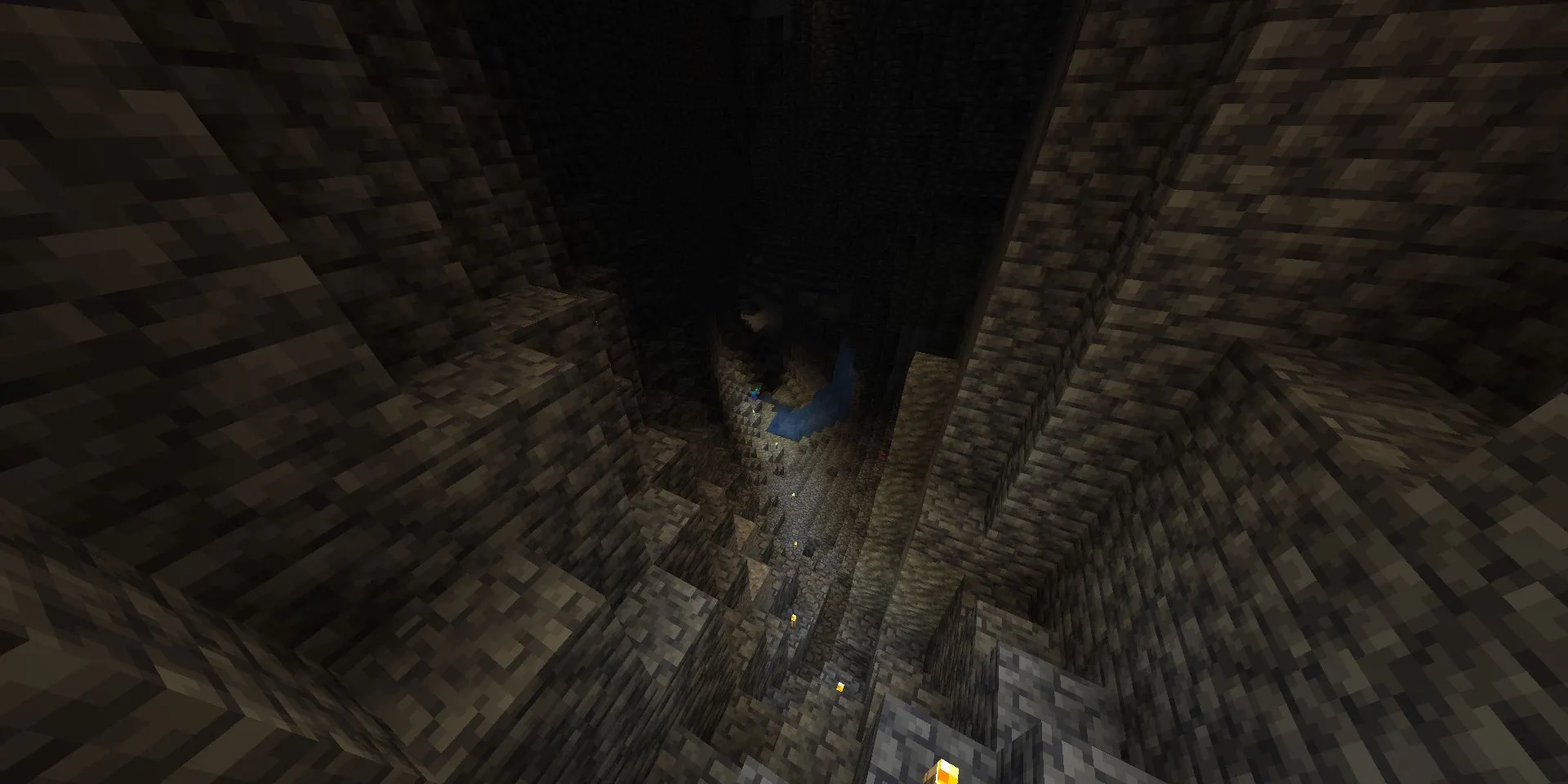 Steve bước xuống hang động được thắp sáng bằng đuốc trong Minecraft