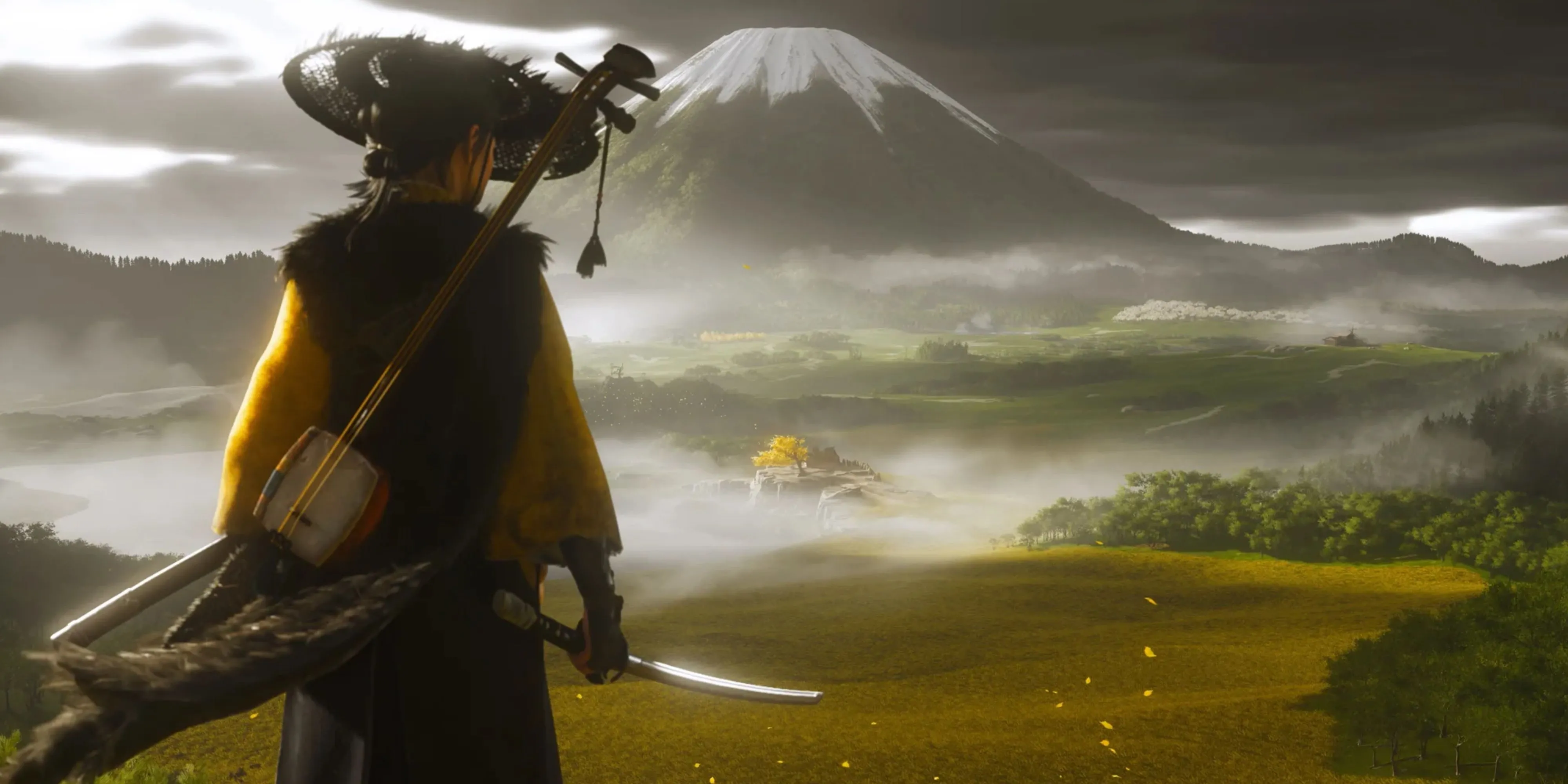 Atsu, nữ anh hùng Ghost of Yotei, đứng trên đỉnh núi tuyết nhìn ra khung cảnh hùng vĩ của đảo Yotei, thể hiện sự tự do khám phá trong game.
