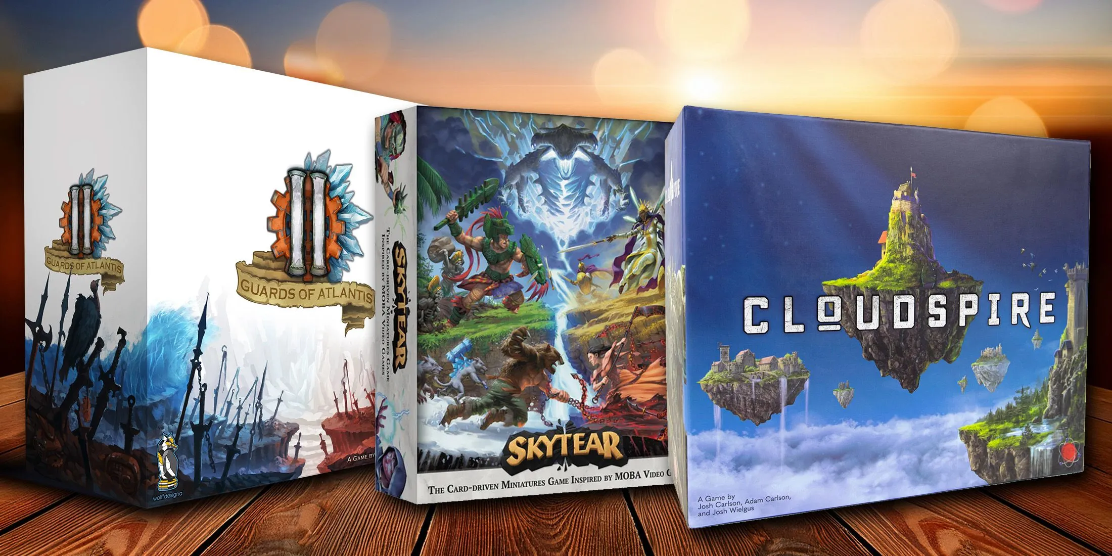 Một bàn chơi được sắp xếp với các board game phong cách MOBA như Cloudspire, Guards of Atlantis II và Skytear.